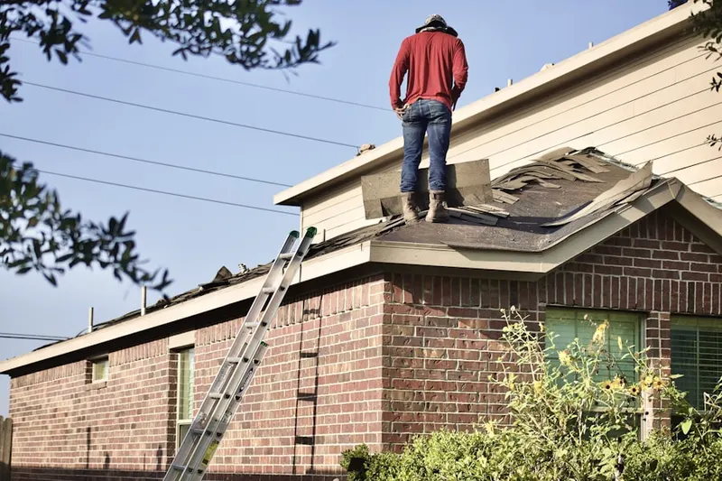 Professional roofer working on a residential roof in Marriott Hill